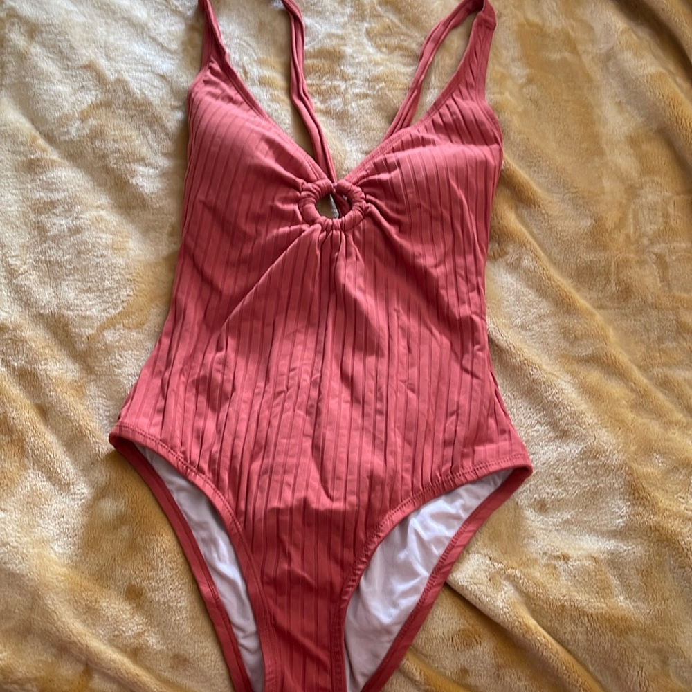 One-piece burnt orange swimsuit with built in padding and open back